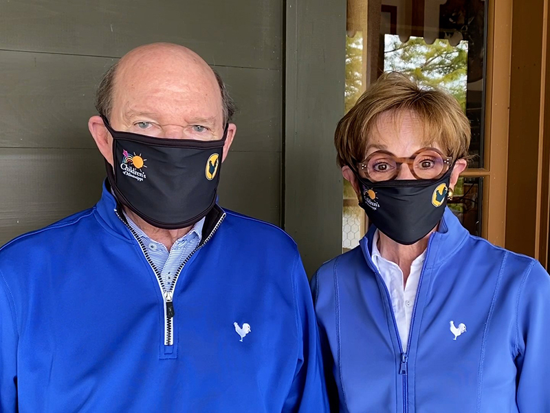 Campaign for Children’s of Mississippi chairs Joe and Kathy Sanderson show the face masks available at sandersonfarmschampionship.com.